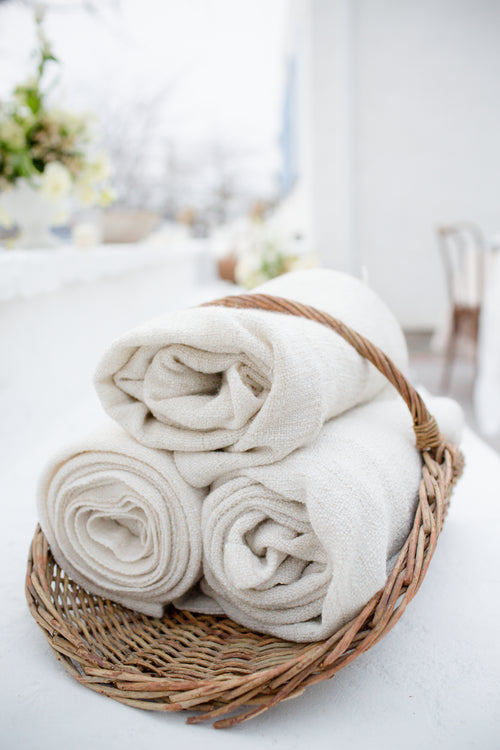 rolled towel fabric-in-a-wicker-basket